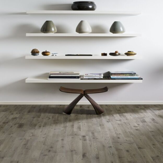 Kahrs Oak Vinga in a room with a table and pebbles on shelves.
