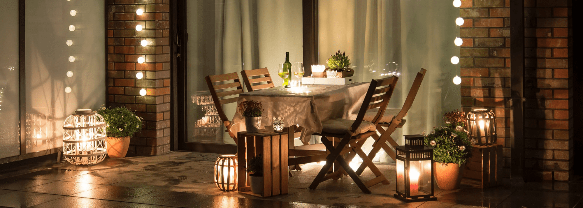 Terrace patio with chairs, a table and fairy lights