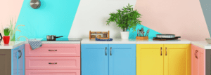 Colourful kitchen with pink, blue and yellow cabinets