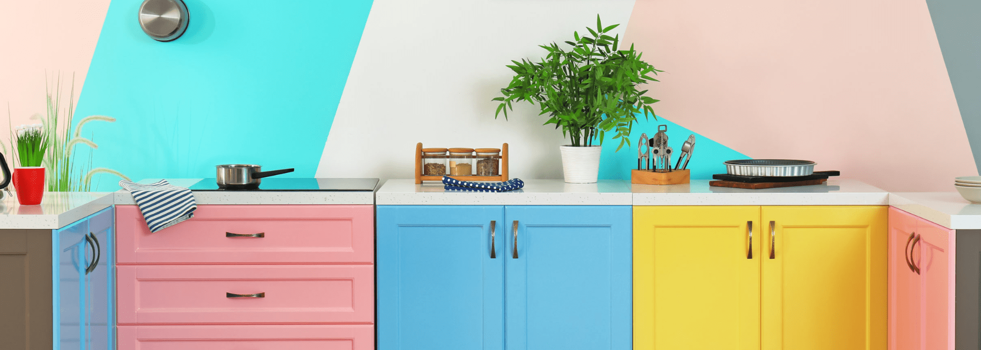 Colourful kitchen with pink, blue and yellow cabinets