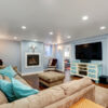 Pastel blue walls in basement living room interior with flooring from Best at Flooring.