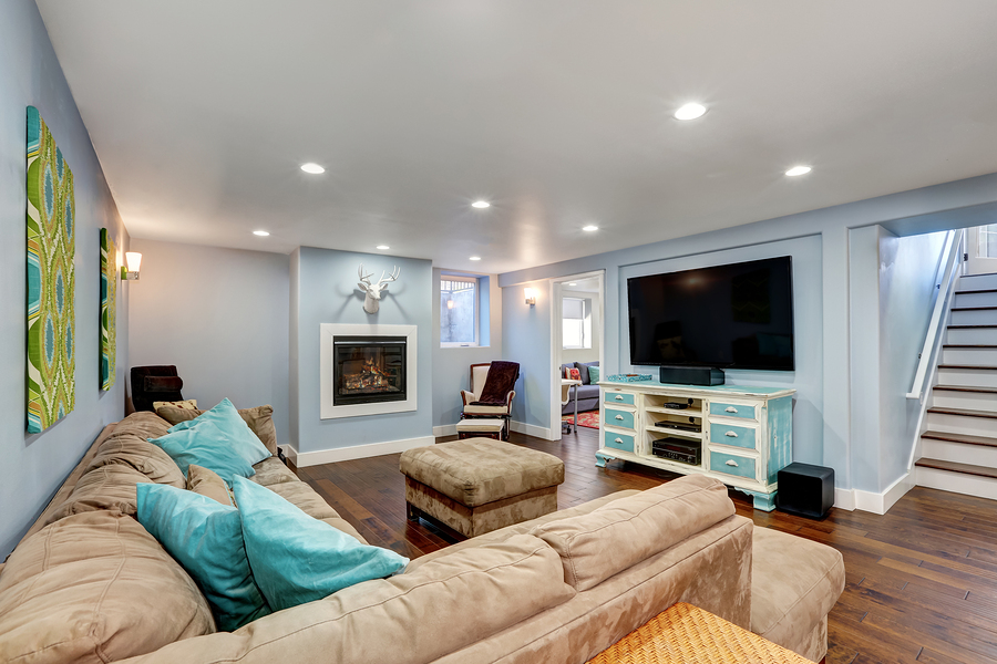 Pastel blue walls in basement living room interior with flooring from Best at Flooring.