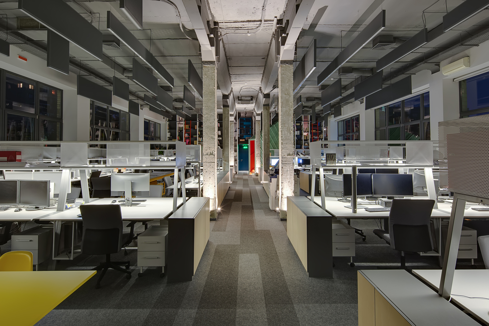 Glowing office in a loft style with grey carpet tiles.