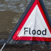 Flood sign in a pool of water