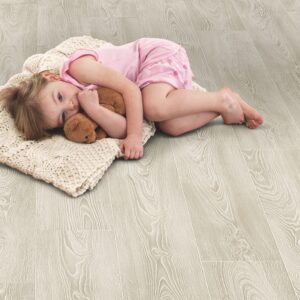 Child lying down with a blanket on ELV207AP Frosted Oak flooring