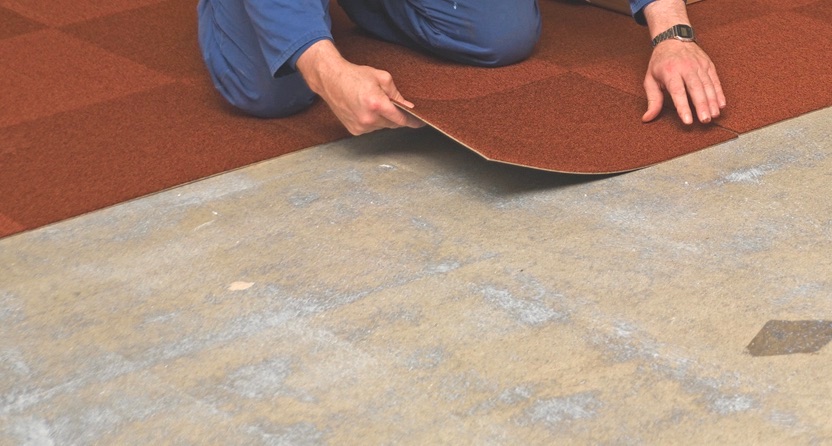 Man laying carpet tiles