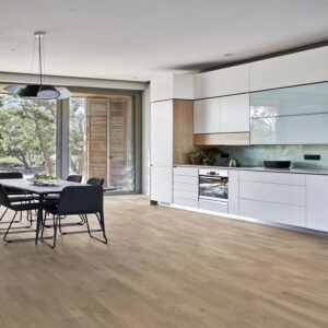 A kitchen and dining area using Kahrs Oak Sand