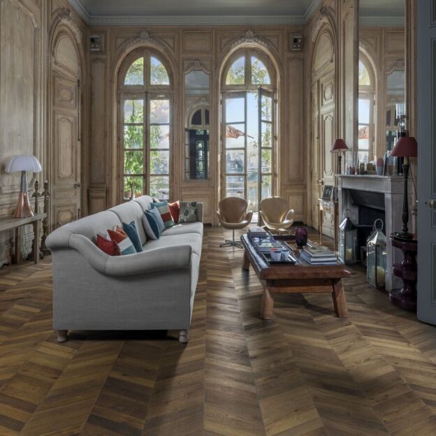 A regal living space using Kahrs ID Chevron Dark Brown flooring.
