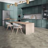 Corner of modern kitchen with white walls, wooden floor, green cabinets and cupboards and long dining table with gray chairs. 3d rendering